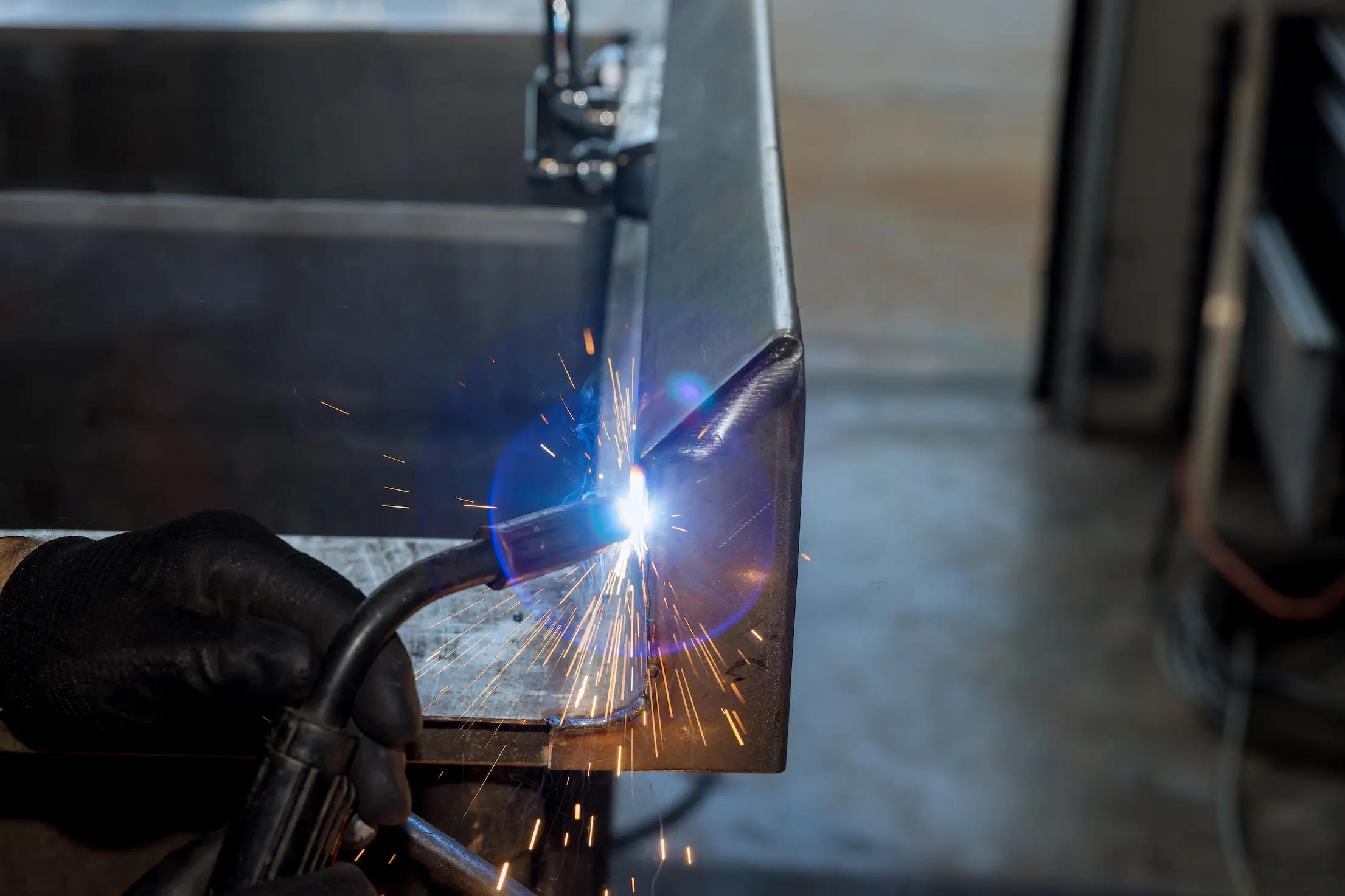 the-worker-is-welding-a-metal-with-sparkle-using-a-2025-03-27-05-48-25-utc